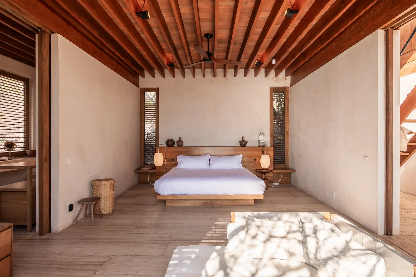 CASA GUAYACAN — La Valise Mazunte: King bed beneath a wooden beam ceiling in Suite Guayacán — La Valise Mazunte