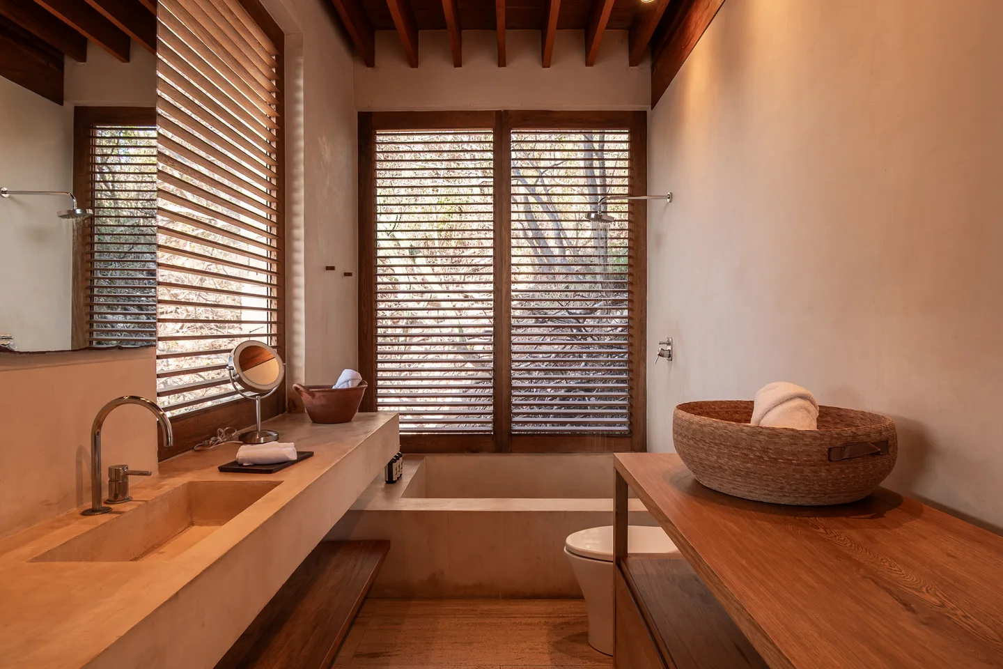 Bathroom of Suite Guayacán with wooden vanity and stone basin — La Valise Mazunte