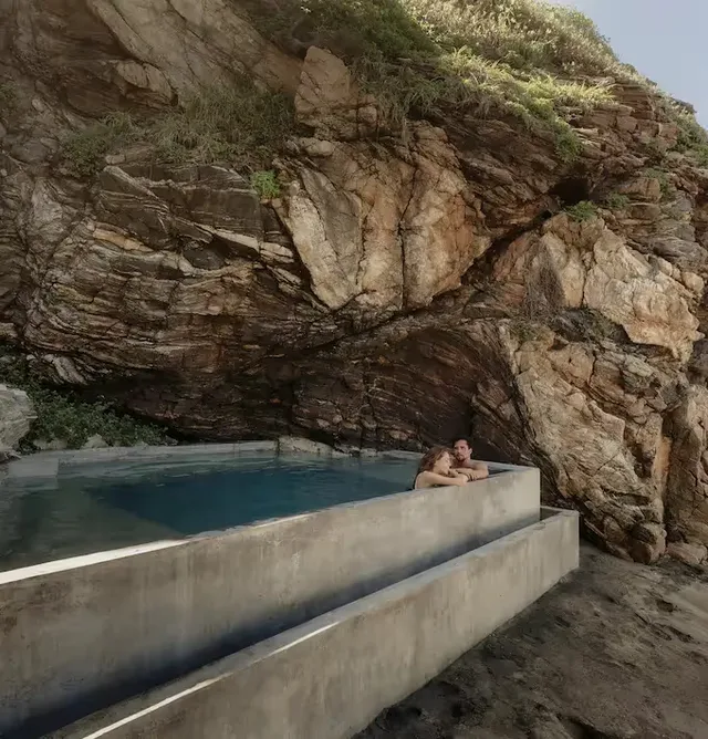 Infinity pool built beneath a natural rock face at La Valise Mazunte